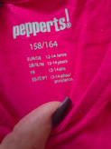 سارافون دخترانه Pepperts! با جنس 100% پنبه، رنگ سرخابی و سایز 158/164، در بستهبندی اصلی با لیبلهای مشخص.
